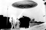 A black and white photo of a saucer-shaped UFO hovering above a white man and white woman in 1950s style clothing.