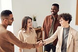 A group of people at work reaching an agreement and looking happy and satisfied with what’s being discussed