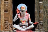 A colorfully painted man sitting in Nepal