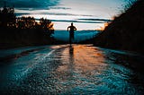 Man running on a street away from the camera