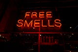 Neon sign reading “Free Smells”