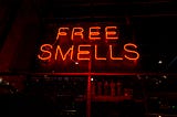 Neon sign reading “Free Smells”