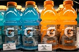 close up on 4 rows of Gatorade for sale in a refrigerator at a grocery store.