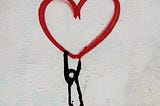 Drawing of stick person holding on to heart.