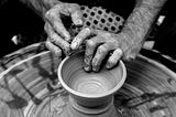 A potter making clay pot of a certain design.