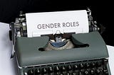 A typewriter with a paper that reads “Gender Roles”