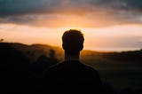 Man watching Muriwai sunset