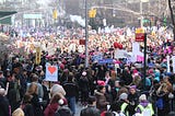 Photo of a large protest of women in the streets, many holding protest signs.