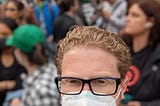 A photo of me in a crowd of people with protest signs.