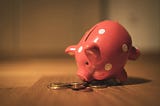 A piggy bank eating money.