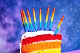 LGBTQIA+ colors birthday cake with candles