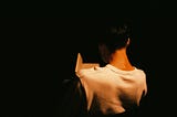 The back of a woman and a notebook