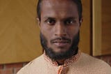 Portrait of Smiling Indian Man with Nose Piercing Looking at Camera