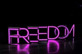 Freedom is written in purple letters with black background.