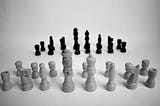 Chess figures without a board on a white table