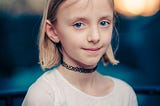 Blue-eyed, blonde girl looking into the camera