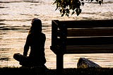 silhouette of woman overlooking the water