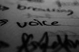 a closeup of the word “voice” written in black ink