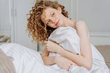 A Woman Sitting on the Bed, Waking Up Happily. What happens when you follow Jeff Bezos’s 1-hour, no-scrolling rule in the morning for 15 days? Does your mental health and productivity improve?