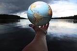 hand holding out globe