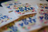 Handmade notes that say “Be a Voter”.”