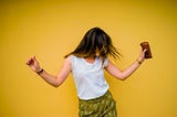 A person dancing with their hair covering their face.