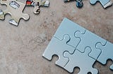 A picture of a jigsaw and various parts coming together