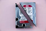 A physical hard drive disk destroyed by cutting it in half diagonally  . Backup files with rclone