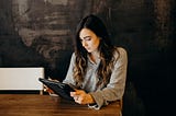 A young woman looking at a tablet computer