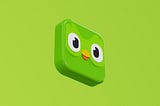 Lime green background. In the centre there is a 3D Duolingo logo. This is a bright green square with two big bird eyes, white with black pupils. There is also a small orange beak.