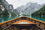 A pretty picture of the prow of a wooden boat on a mountain lake — that has no relation to the blog post