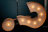 An unusual question mark with lighting and a dark background.