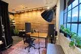 Photo of Relationary’s new studio featuring recording table, wood-paneled wall, and studio lighting.