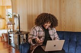 women on video call on laptop