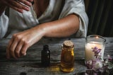 Image of person using a dropper to put a medicinal tincture on their forearm.