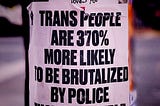 sticker on a pole beneath a smaller one that reads: jesus loves you reads in bold black letters against white: trans people are 370% more likely to be brutalized by police than cis people.