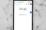 Photo of iPhone with Google Search open.