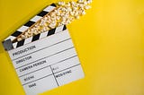 movie production tool, with popcorn, yellow background!