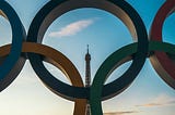 They Olympic rings in front of the Eiffel Tower