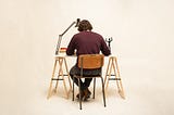 A man sits at a desk.