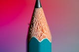 Close up of pencil, background gradient of red to blue