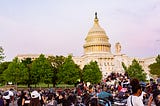 Photo of people of color and white people gathered in front of the U.S. Capitol.