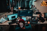 A person sits at their desk, using their workstation with displays of varying physical size