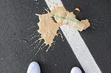 Iced coffee spilled on asphalt