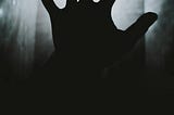 Grayscale image of a human hand silhouette showing five fingers. Alt text to show the importance of alt text.