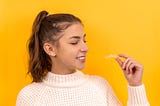 a girl holding an invisible braces