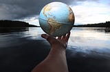 Hand holding a globe of the world