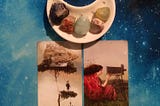 Photo of 2 Mystical Moments Oracle Cards with crystals in a moon-shaped dish on a starry background