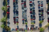 A bird’s view of a full street side parking lot