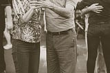 Old person dancing with middle aged person
